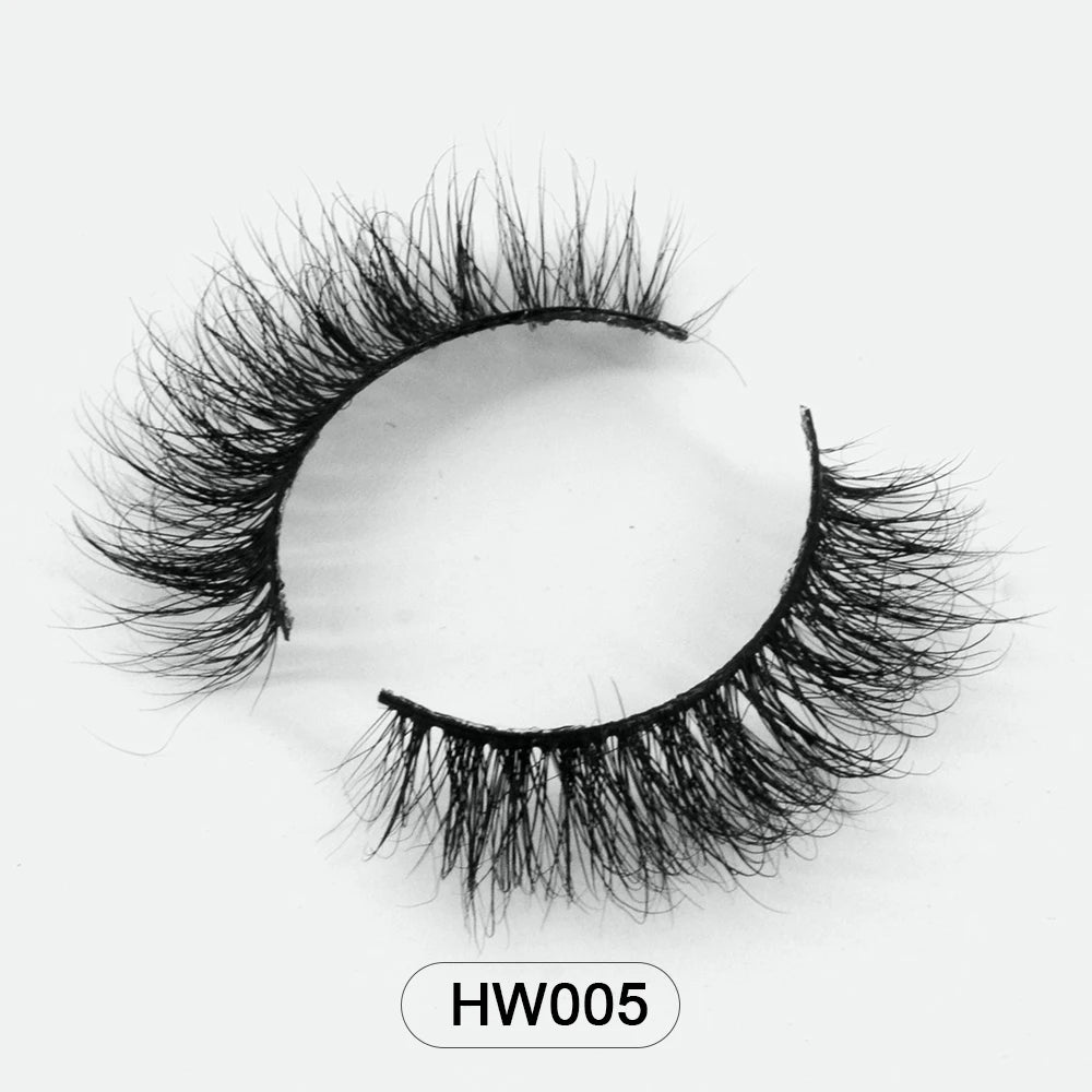 Pair of black 3D mink false eyelashes with a soft, flexible band and flared, wispy volume. Label reads HW005.