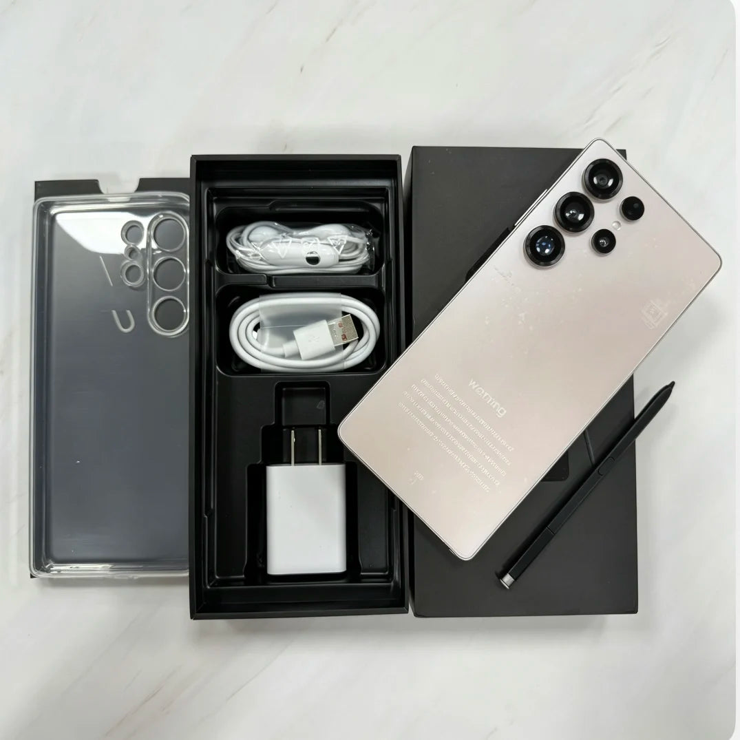 Gold smartphone with cables and charger in open box, accessories visible.