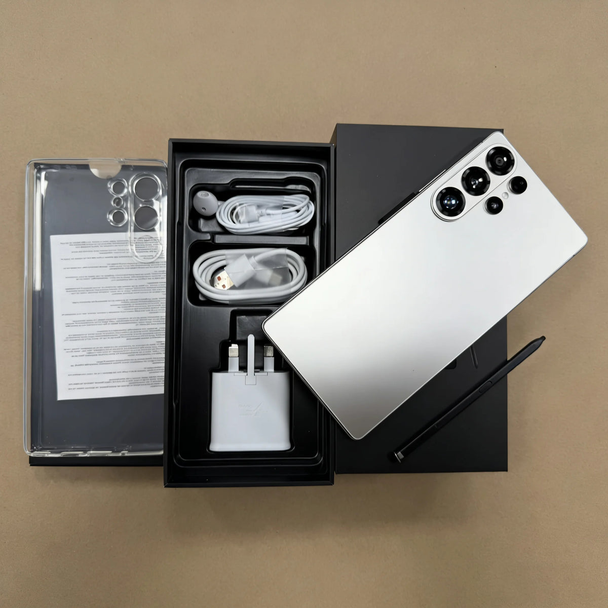 Unlocked 5G smartphone unboxed: white phone with rear camera array, accessories included