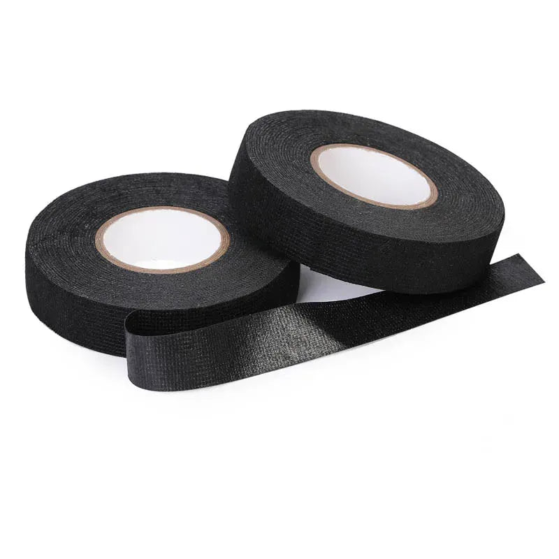 Black woven fabric tape rolls with loose strips extending between the coils