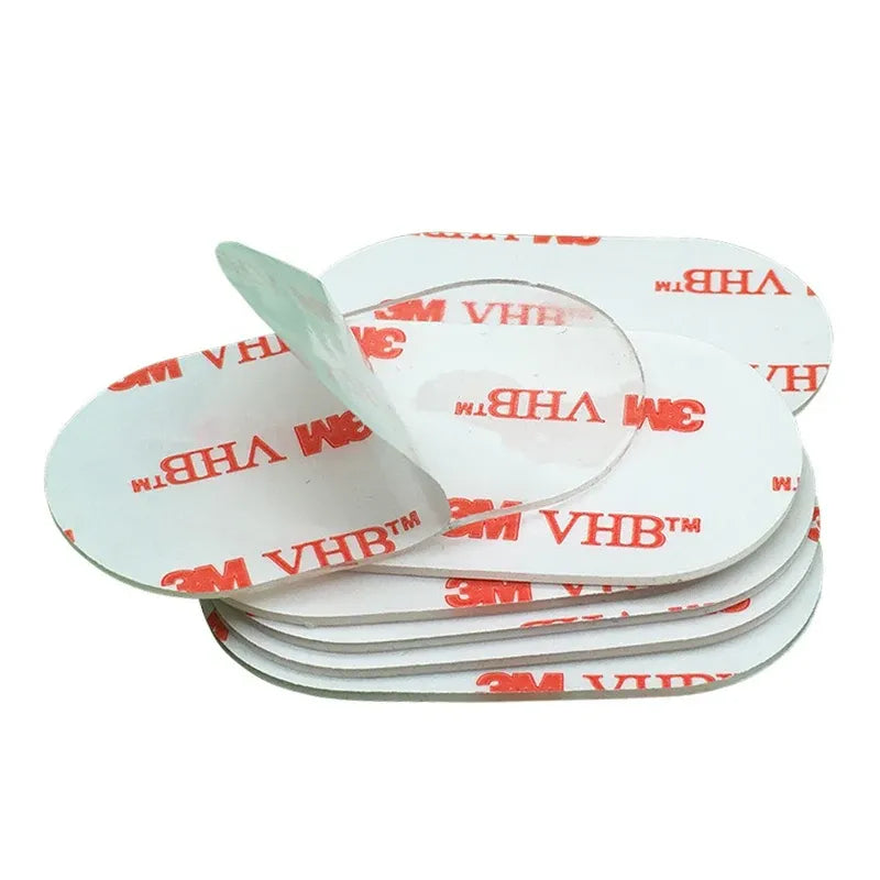 Stack of clear double-sided acrylic foam tape pads with white release liners