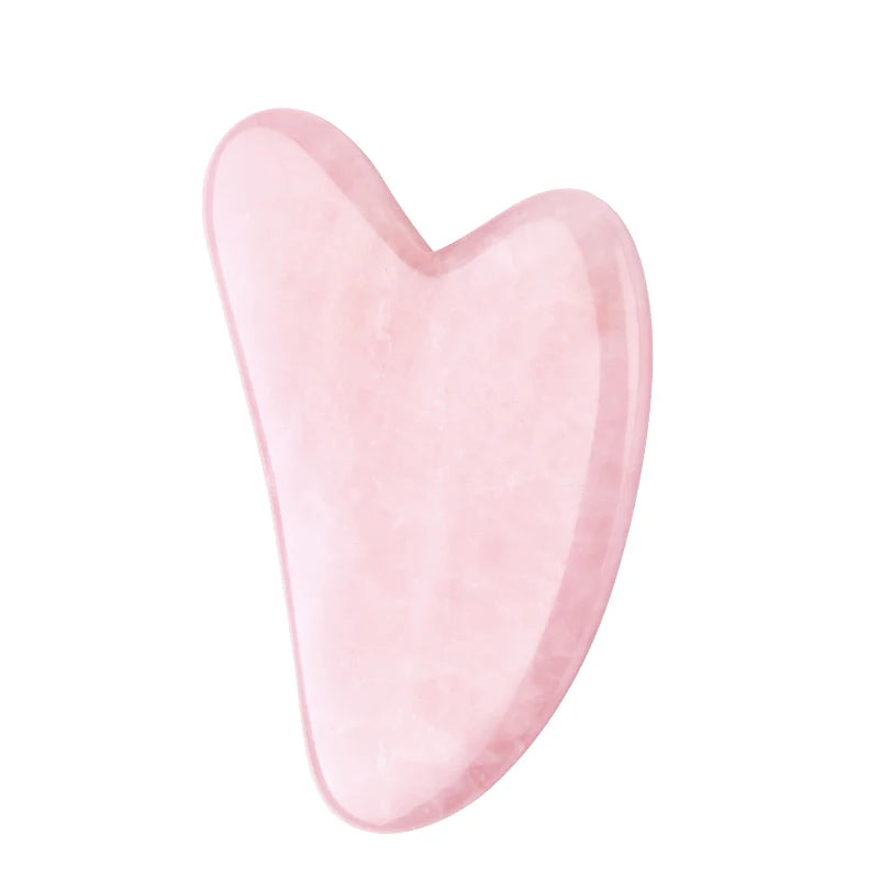 Heart-shaped pink rose quartz gua sha facial massage tool with a smooth, polished stone texture.