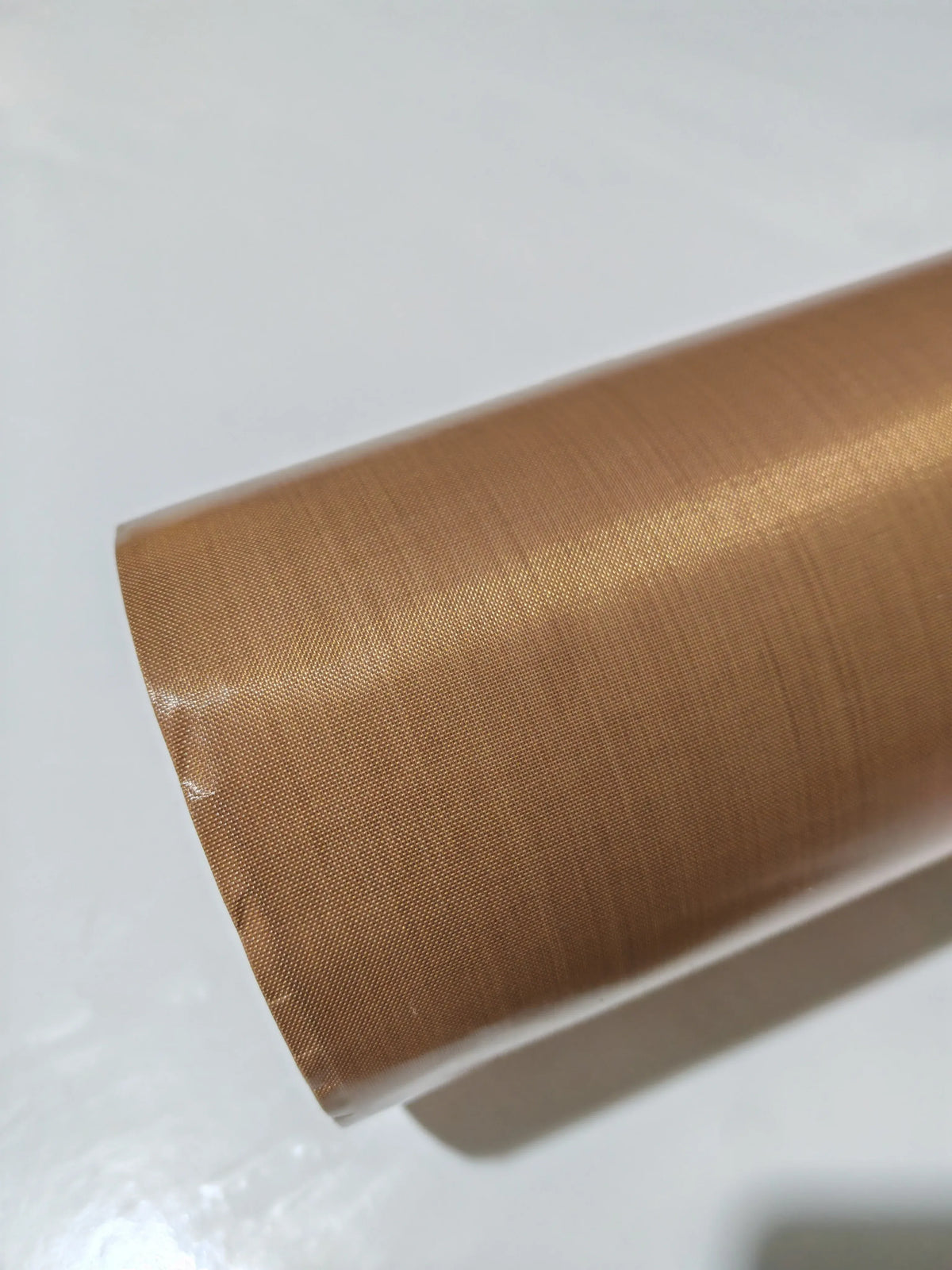 Brown PTFE tape roll end showing tightly wound layers