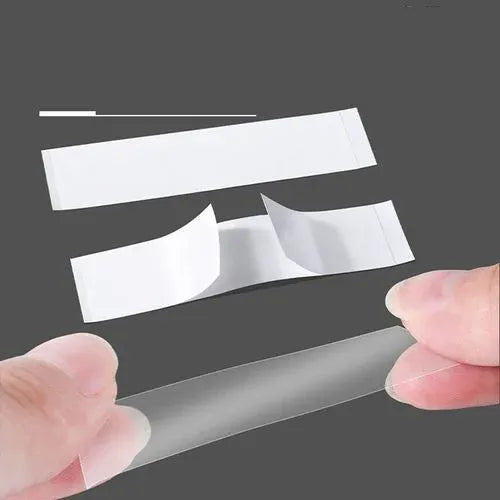 Transparent adhesive tape strips held in hands on a dark background