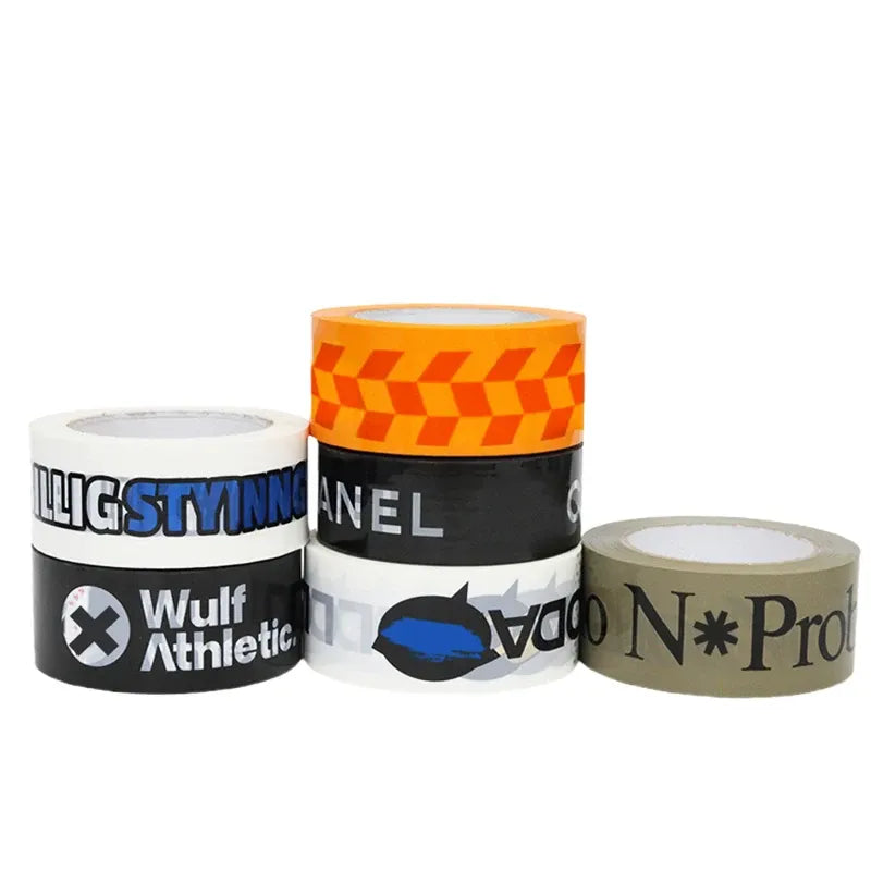 Packing tape rolls with colorful printed labels on cores, orange and black tape