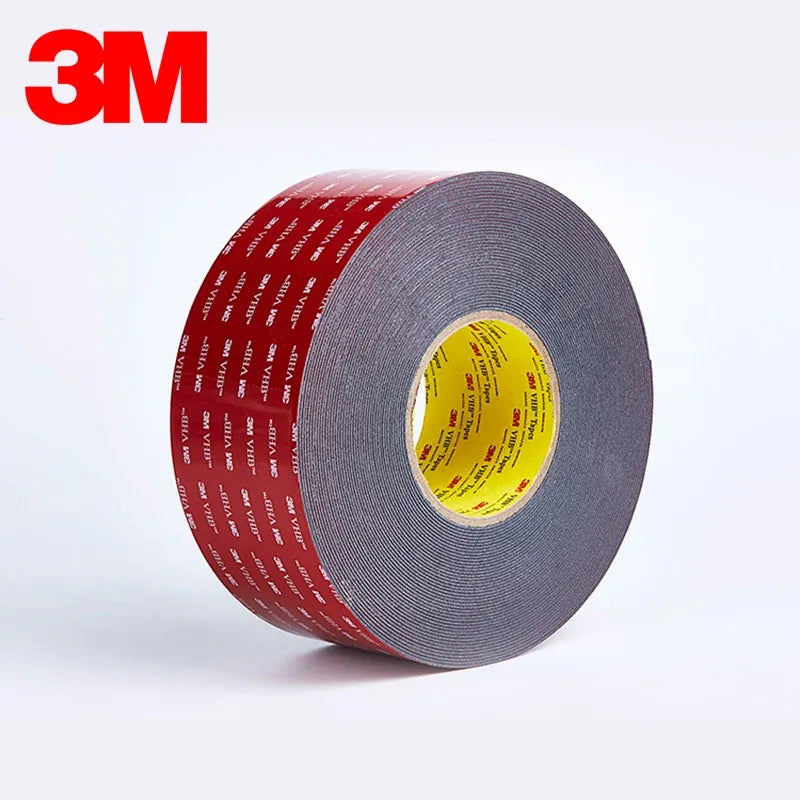 Red double-sided foam tape roll with gray core, tightly wound