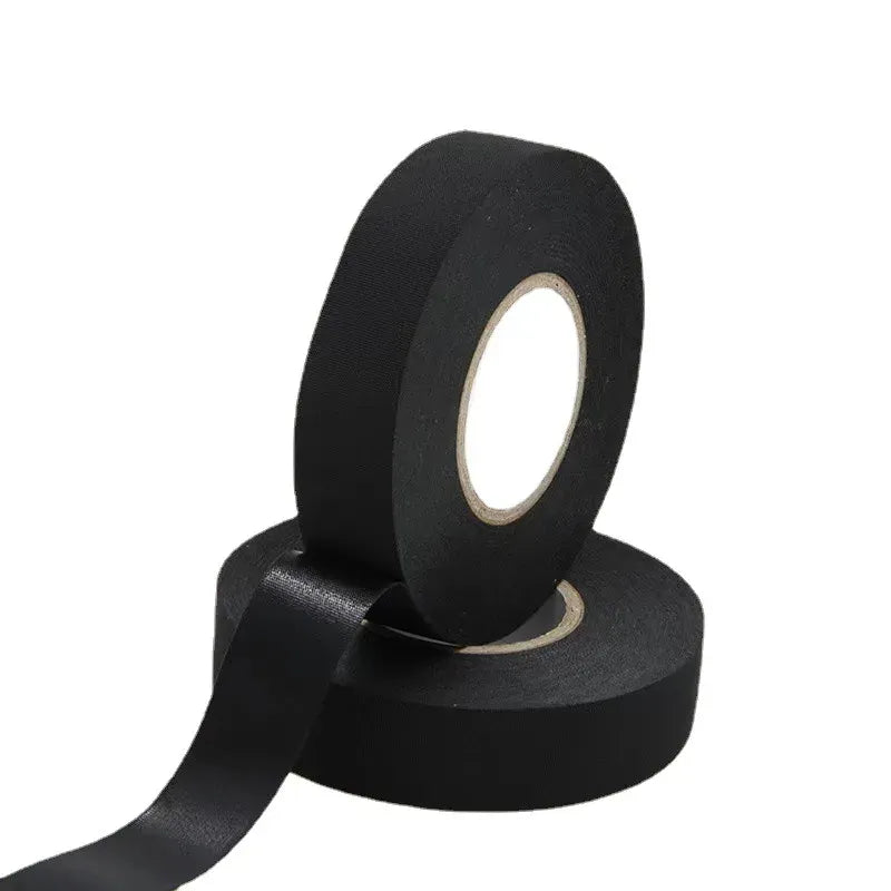 Black insulation tape roll with backing strip unwound and core end visible