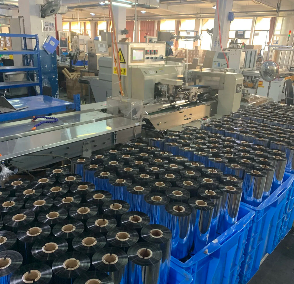 Thermal transfer ribbon spools packed on production rack inside a facility