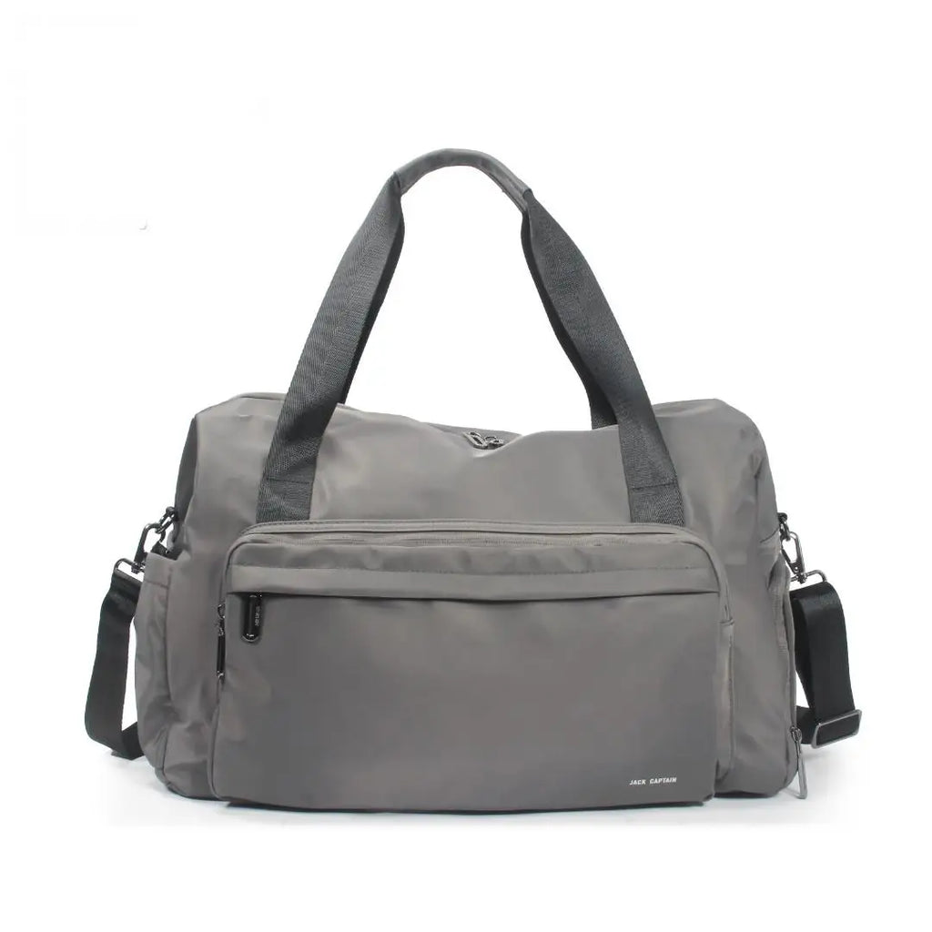 Grey waterproof nylon travel duffel bag with zipper pockets, dual handles, and an adjustable shoulder strap for trips.
