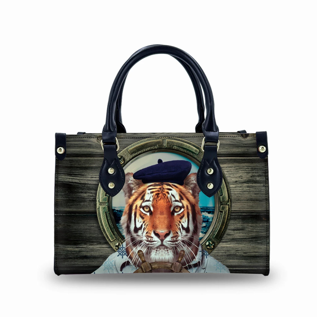 Vintage style PU leather trunk bag featuring a tiger in a beret porthole print with black handles and buckle detail.