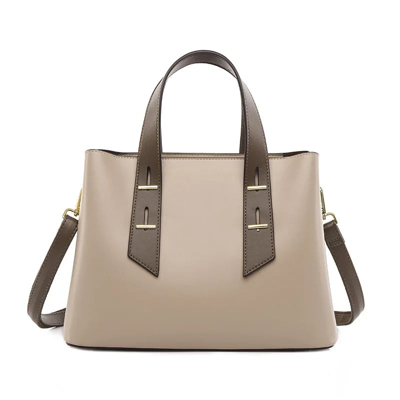 Beige luxury designer handbag with brown handles, gold hardware, and detachable shoulder strap.