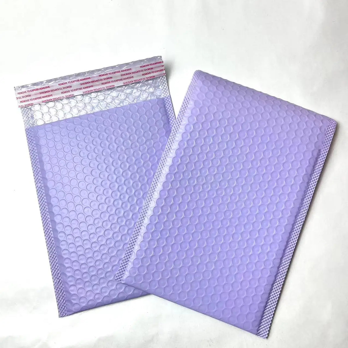 Lilac bubble mailer shipping bags with raised bubble-texture poly surface.