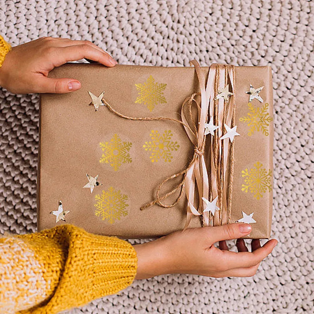Transparent circle gold-foil sticker labels with snowflake design on gift box