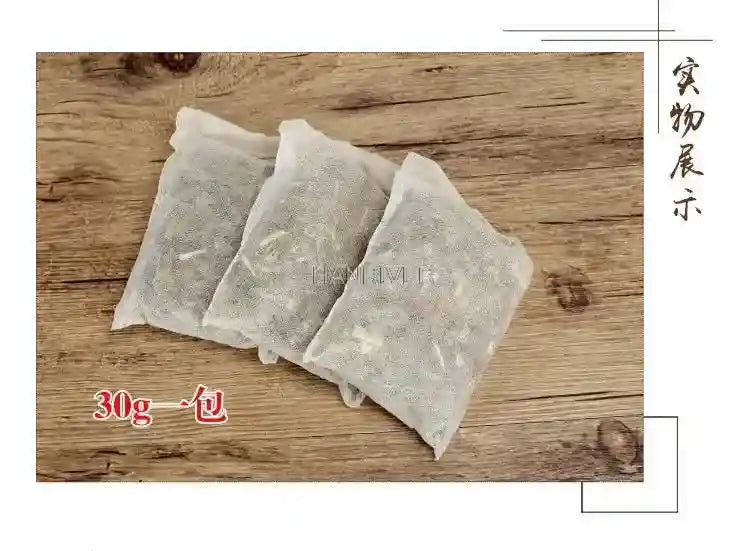 Three 30g herbal foot soak bags with ginger, wormwood, and safflower for relaxing home spa baths on wood background.