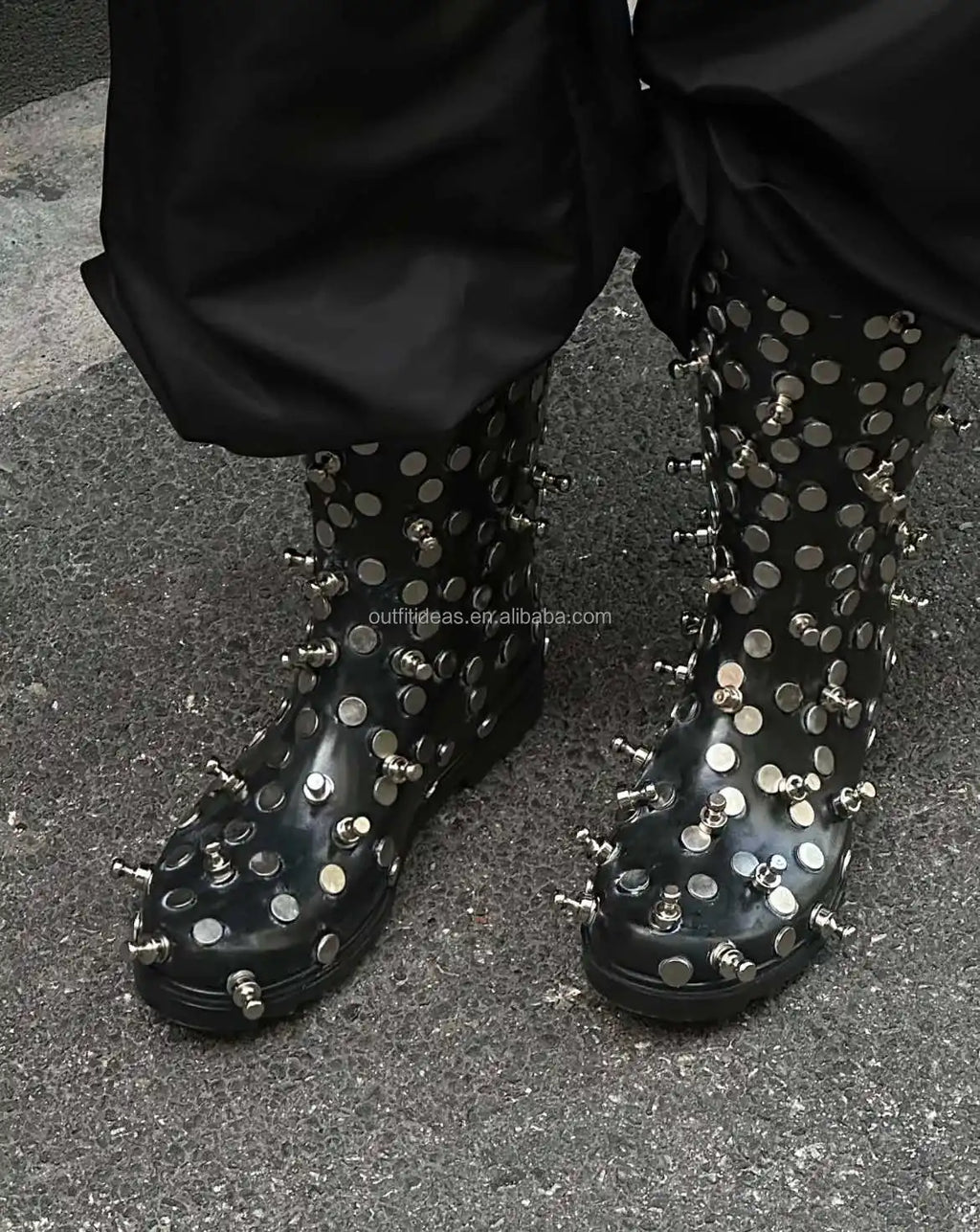 Black studded mid-calf boots, glossy leather material, silver spike embellishments, and a chunky rubber platform sole.
