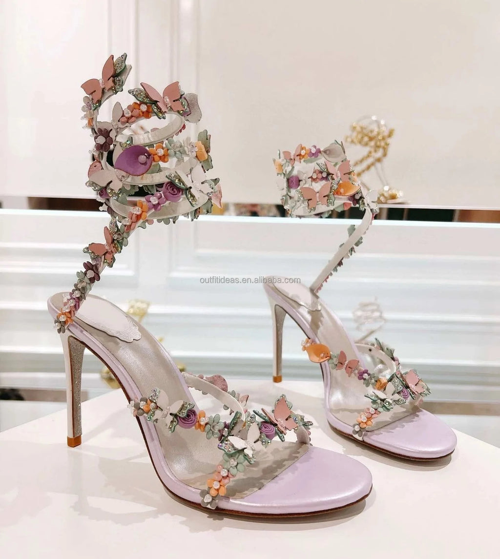 Lavender satin stiletto sandals with 3D floral butterfly embellishments, ankle wrap, perfect for luxury bridal wear.