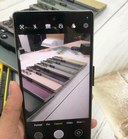 7.3-inch Android smartphone showing camera controls and live view on the screen