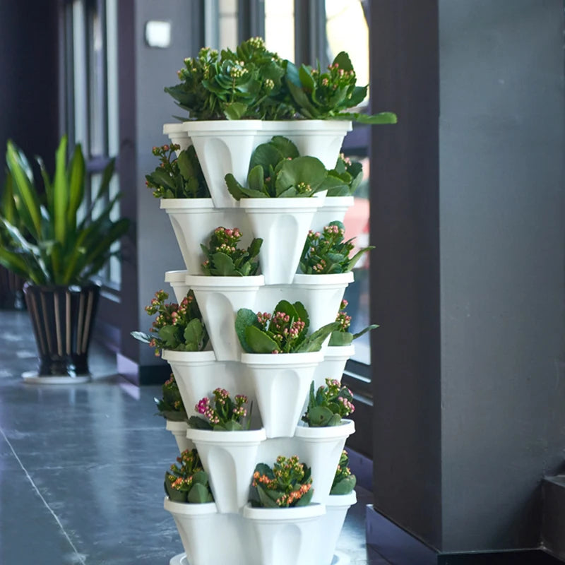 Stackable vertical flower pot planter tower, white plastic with small potted plants