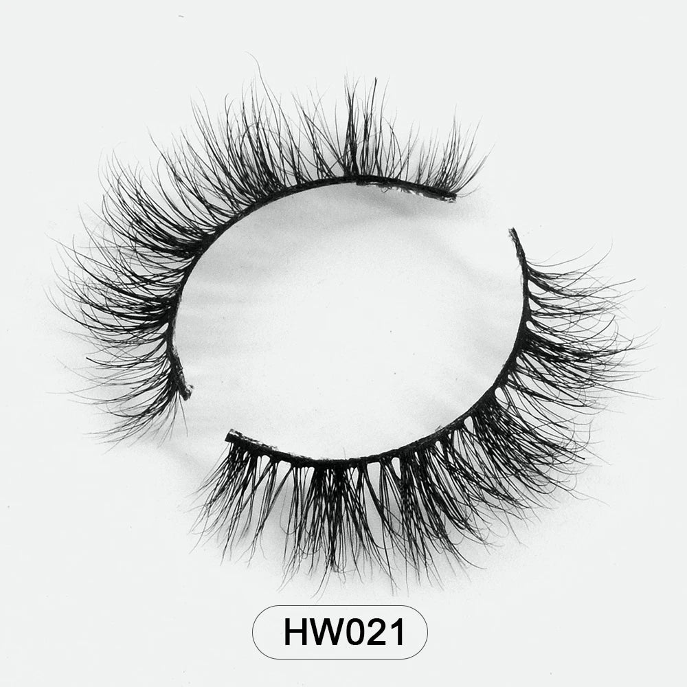 A pair of black 3D mink false eyelashes with a thin, flexible band arranged in a circular shape.