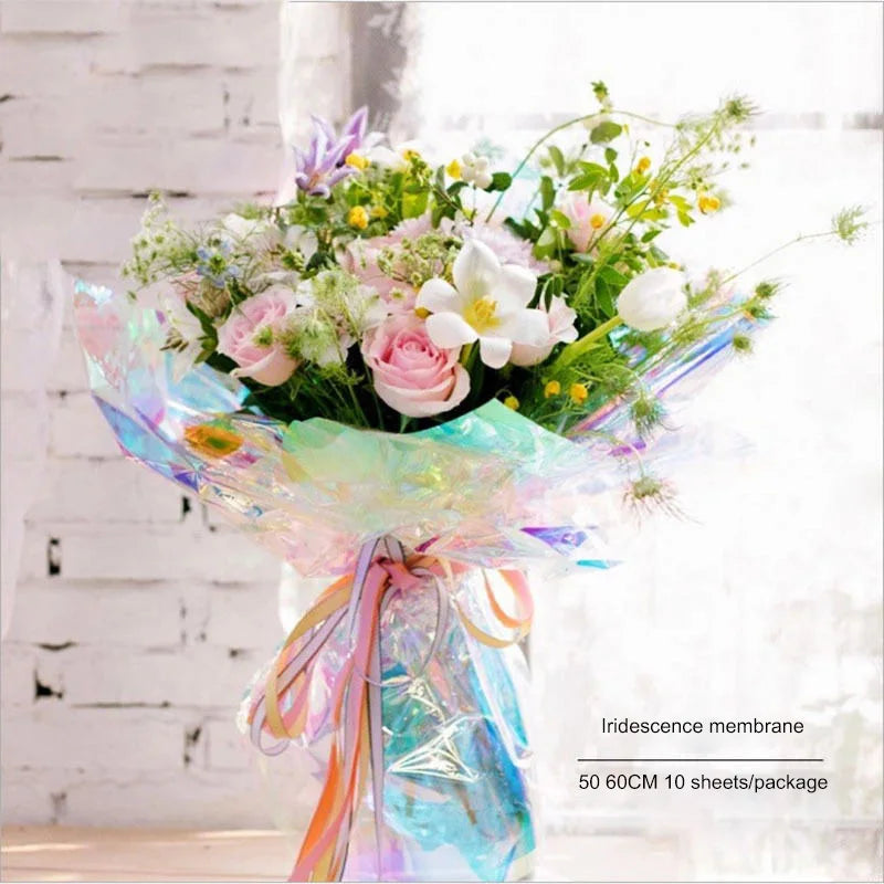 Iridescent holographic bouquet wrap with pink and blue ribbon tie, flowers bundled inside