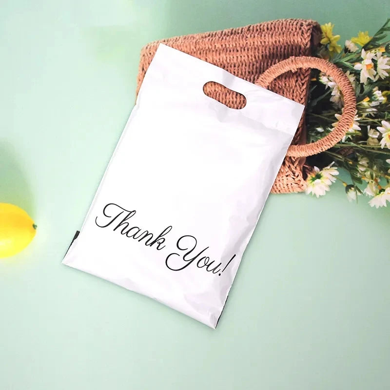 White plastic poly mailer bag with "Thank You!" script print, top handle cutout