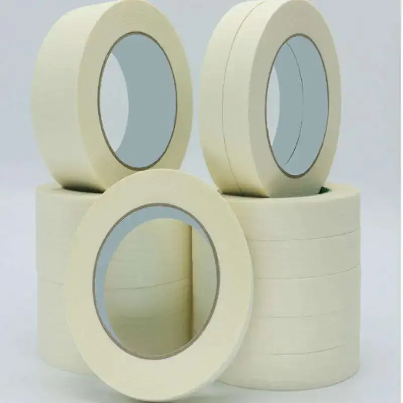 Light yellow masking tape set of rolls with oval cores facing the camera