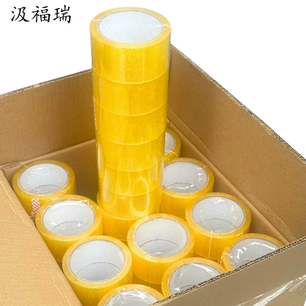 Yellow packing tape rolls in a cardboard box, showing the dispenser cores