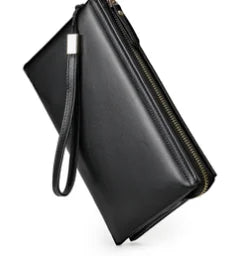 Black genuine leather wristlet clutch with a top zipper, sleek minimalist designer style for women.