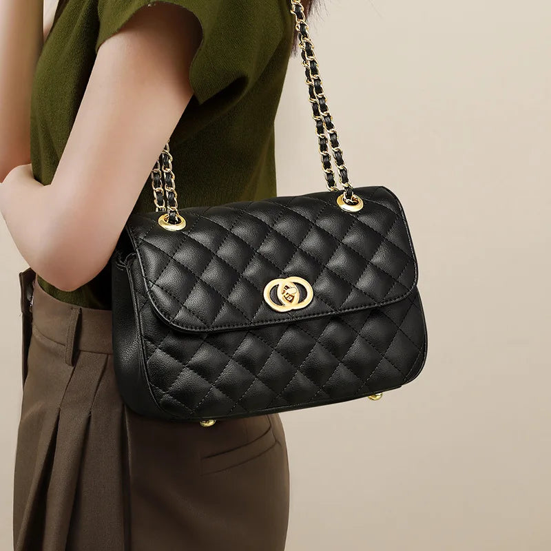 Black quilted genuine leather shoulder bag with gold turn-lock closure and chain strap for women. Trunk style purse.