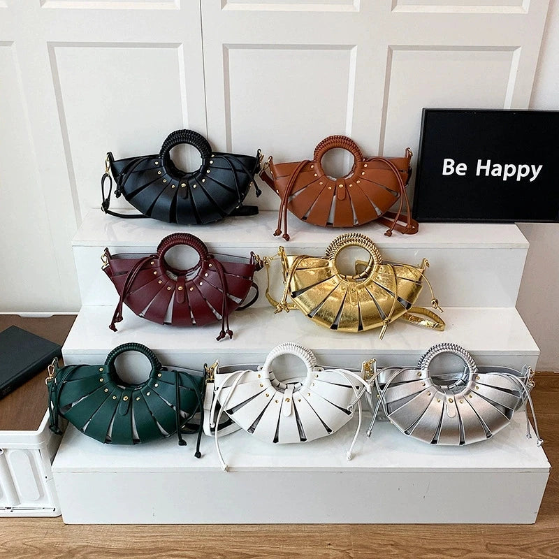 Luxury half moon trunk handbags in various colors featuring circular handles and hollow-out leather cutout designs.