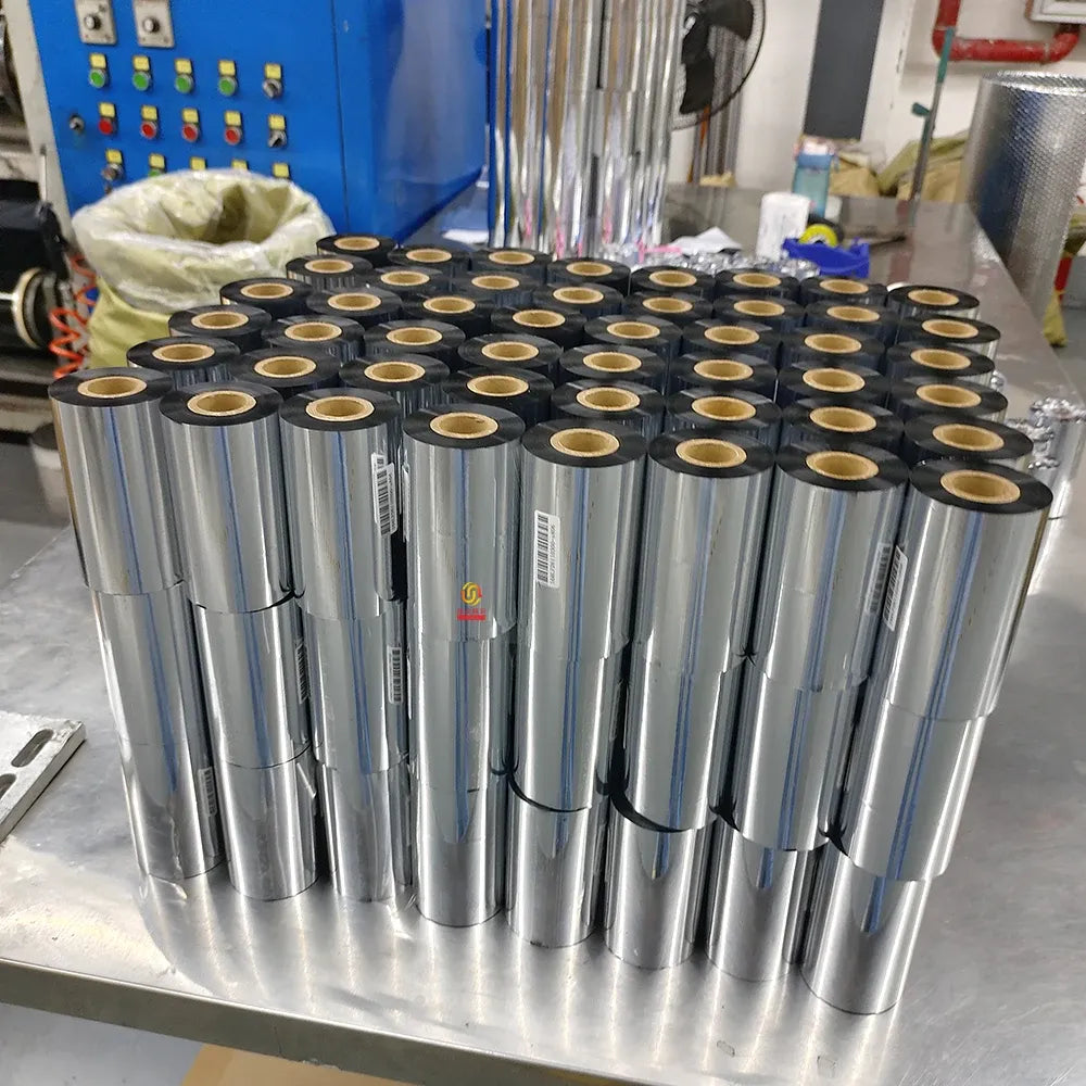 Large bundle of black resin thermal transfer ribbon spools on a vertical metal rack
