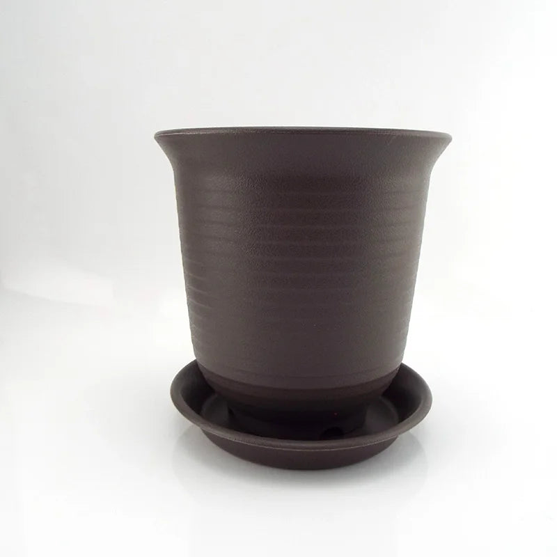 Dark gray plastic flower pot with saucer base, shown from front on white background.