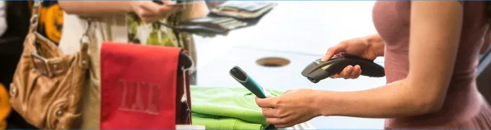 Hands using a handheld barcode scanner to scan items