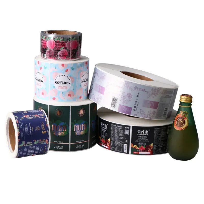 Assorted printed label rolls in multiple colors with visible cores and tape.
