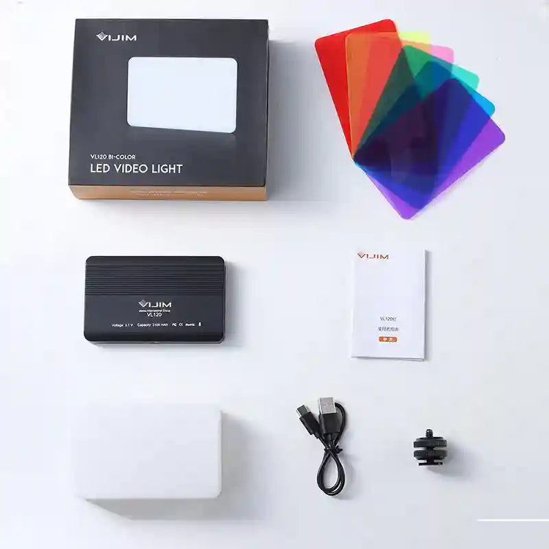 Bi-color LED video light, rectangular black panel, colored light filters, charging cable, and mounting adapter.