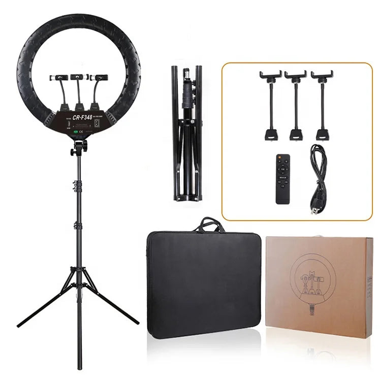 Black LED ring light with tripod stand, three phone mounts, remote, power cord, carrying case, and box for content.