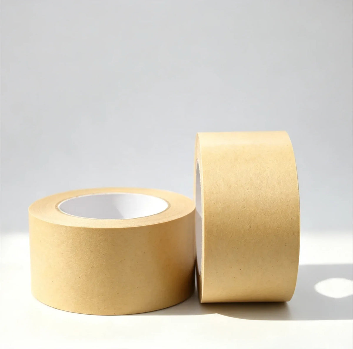 Brown kraft paper adhesive tape, 48mm, two rolls and unrolled strip