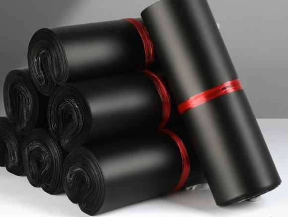 Rolled plastic mailing bags, black, with red securing bands