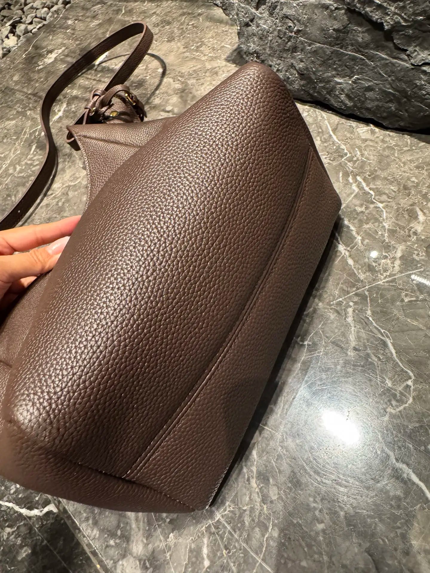 Brown genuine leather hobo shoulder bag with a pebbled texture, adjustable strap, and luxury messenger design.