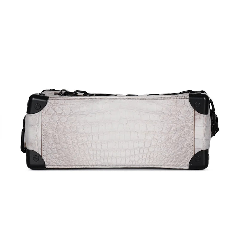 White Himalayan crocodile leather trunk bag with black metal corners and chain strap, luxury mini crossbody design.