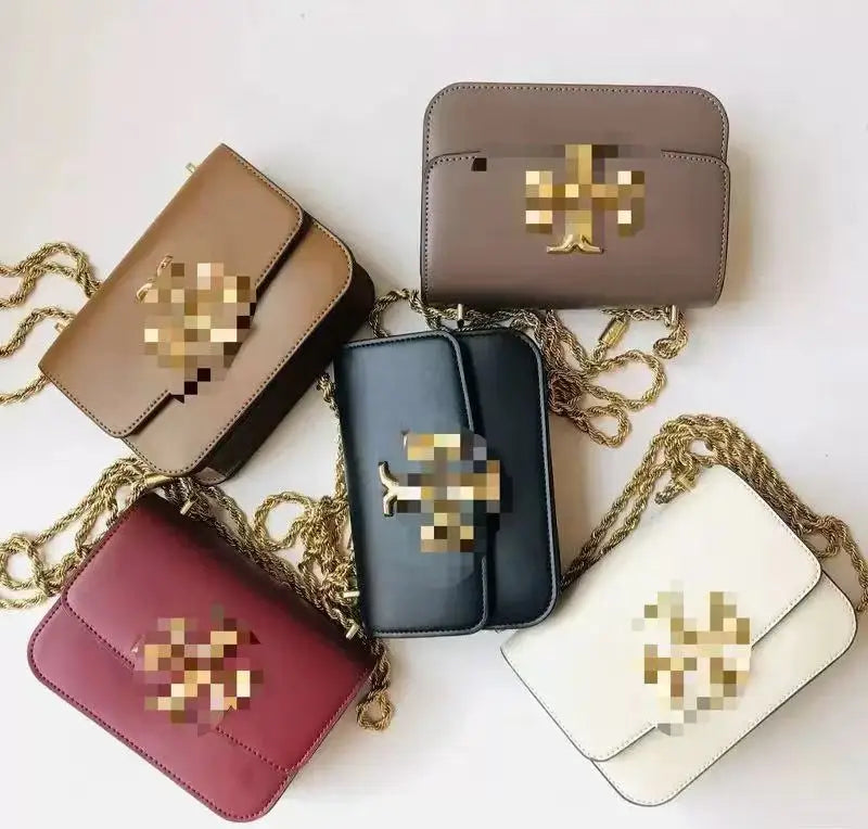 Multi-color leather trunk crossbody bags with gold metal chains and front logo hardware in assorted classic shades.