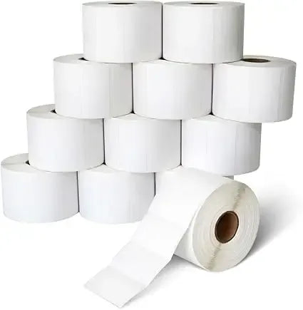 Stack of white self-adhesive thermal label rolls with blank rectangular labels