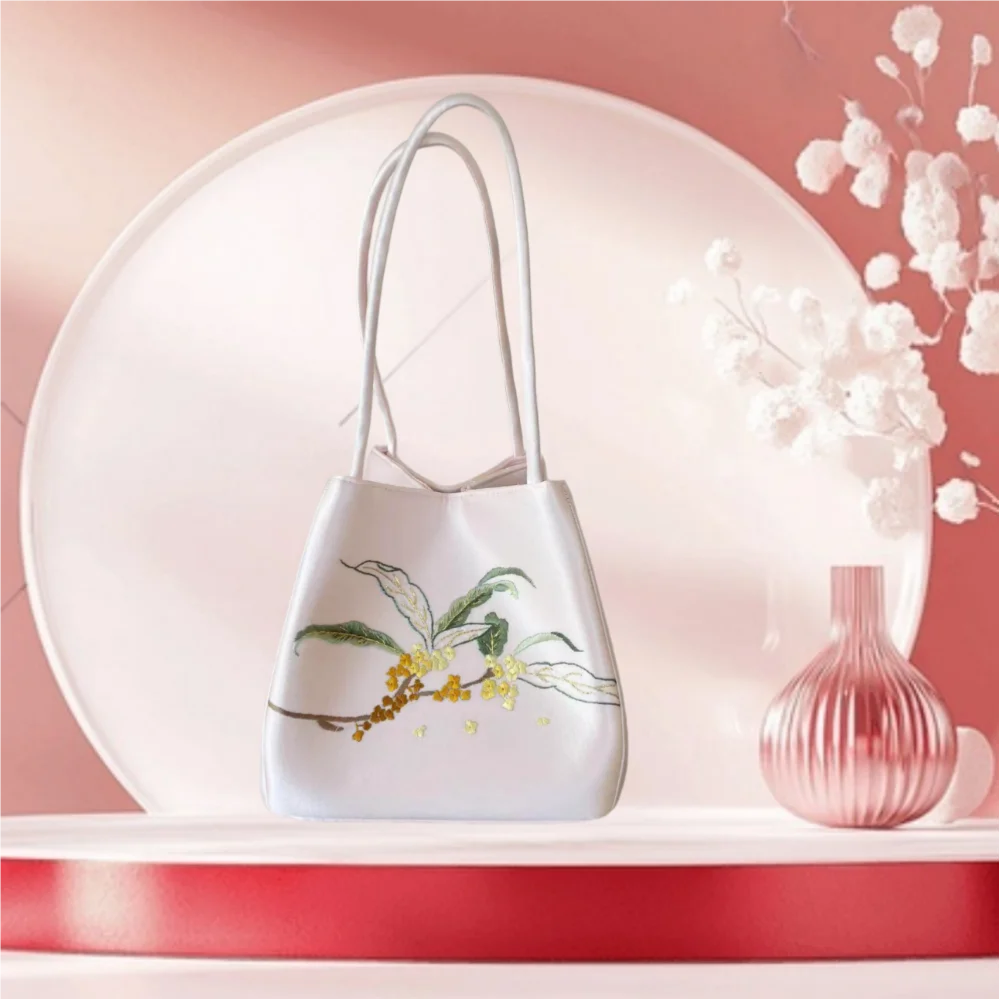 White silk shoulder bag featuring traditional Chinese Su embroidery of yellow flowers and green leaves. Trunks style.