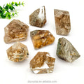 Assorted polished phantom quartz crystals arranged together, clear with brown-gold inclusions