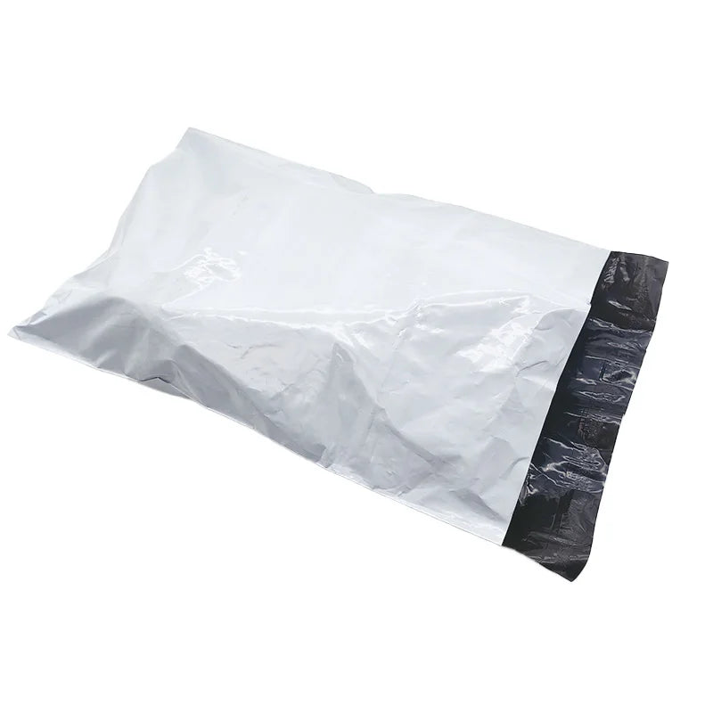 White poly shipping bag with glossy black side panel, folded and crinkled.
