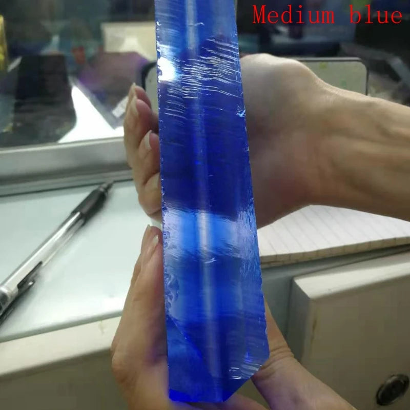 Medium blue synthetic hydrothermal crystal prism, close-up from side angle.