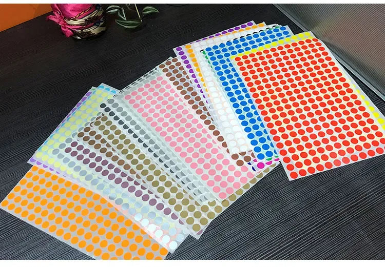 Glow-in-the-dark dot sticker sheets with multicolor foil polka-dot panels