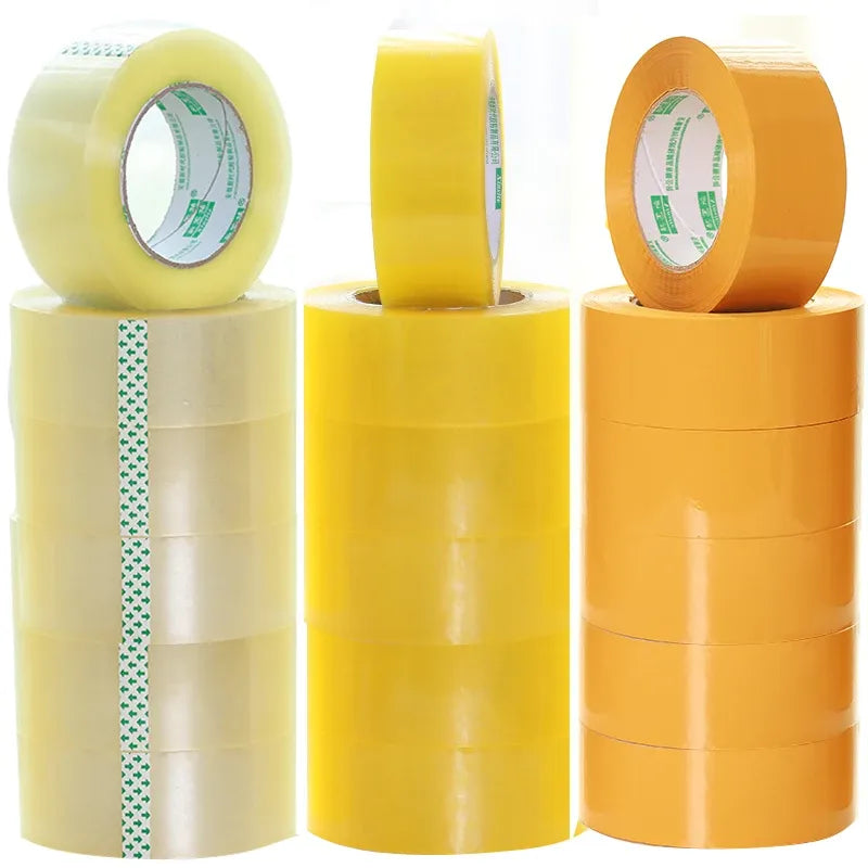 Multiple rolls of BOPP packaging tape in clear, yellow, and orange colors