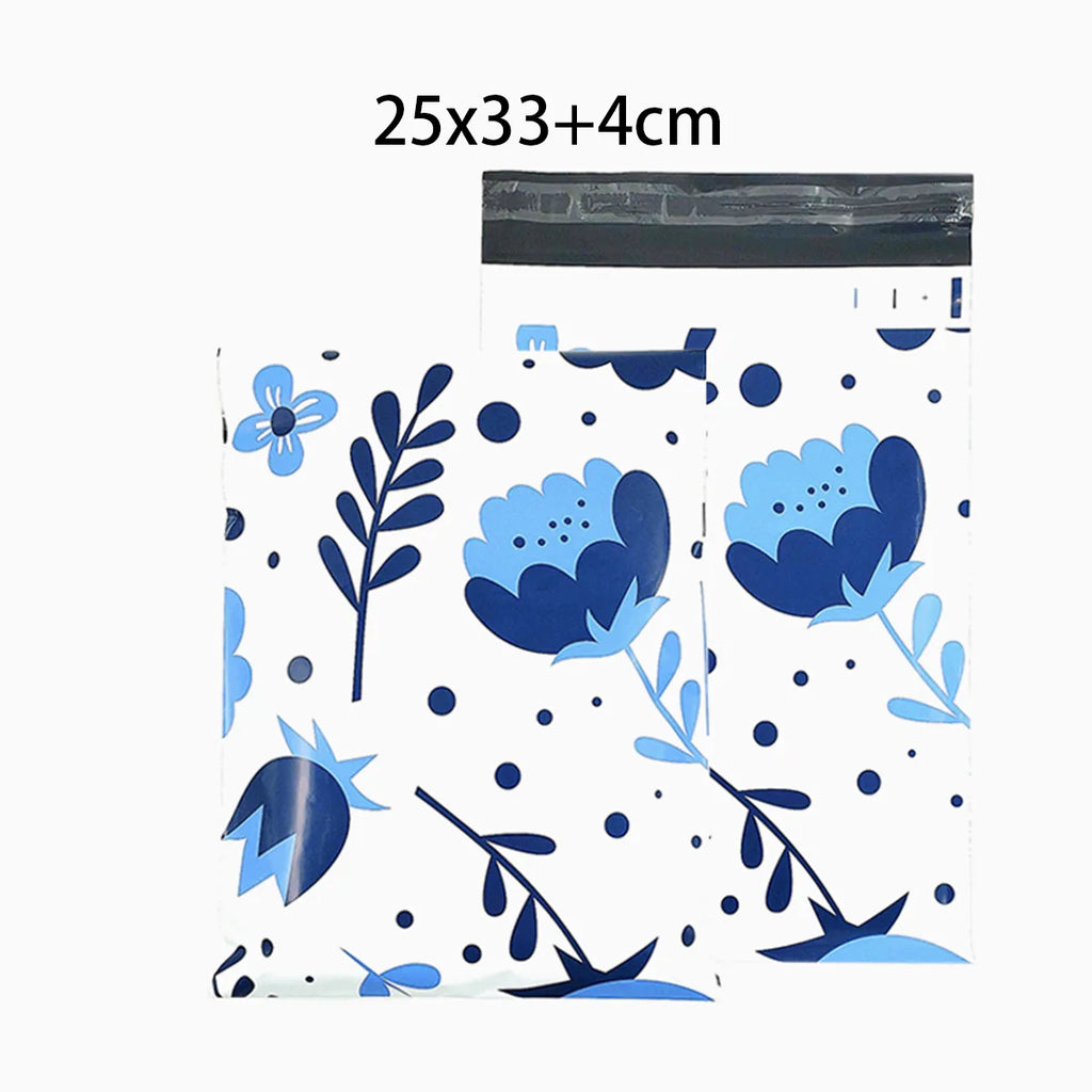 White poly mailer with blue flower and leaf pattern, size text at top