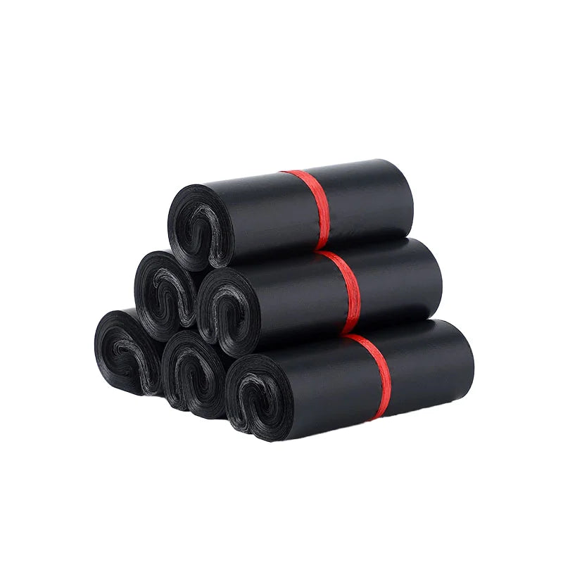 Stack of black thick poly self-seal shipping mailers, rolled and banded